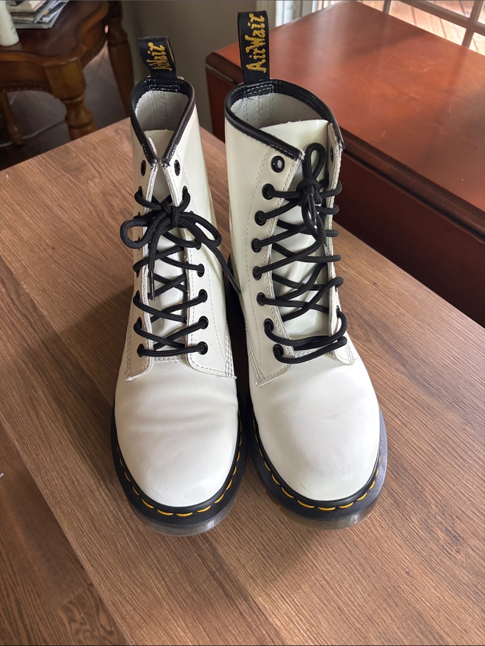 These are white Dr. Martens 1460 smooth leather combat boots.